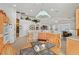 Open-concept kitchen featuring wood cabinets, tile floors, and an adjacent dining area at 6710 Pyracantha Glen Ct, Las Vegas, NV 89131