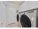 Convenient laundry room featuring modern washer and dryer units and ample storage space at 6710 Pyracantha Glen Ct, Las Vegas, NV 89131