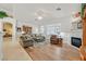 Comfortable living room with wood flooring, a fireplace, and bright window shutters at 6710 Pyracantha Glen Ct, Las Vegas, NV 89131