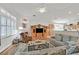Open-concept living room with a fireplace and seamless connection to the kitchen at 6710 Pyracantha Glen Ct, Las Vegas, NV 89131