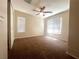 Bedroom with neutral walls, carpet, ceiling fan, and natural light from windows with blinds at 7017 Green Ripple Ln, Las Vegas, NV 89156