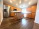 Bright kitchen features stainless steel refrigerator and wood grain cabinets and island at 7017 Green Ripple Ln, Las Vegas, NV 89156