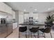 Modern kitchen with stainless steel appliances, black countertops and a large center island at 73 Lomita Heights Dr, Las Vegas, NV 89138