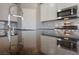 Close up of kitchen with black granite countertop, stainless steel microwave and faucet at 73 Lomita Heights Dr, Las Vegas, NV 89138