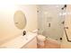 Modern bathroom featuring a glass shower, pebble floor, a built-in niche, toilet, and white vanity at 7329 Daily Double Ave, Las Vegas, NV 89129