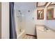 Bright bathroom featuring a shower-tub combination, a sink with a wood framed mirror at 798 Shirley Ln, Boulder City, NV 89005