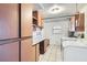 Functional laundry room with white appliances, ample cabinetry, countertop space and white tile flooring at 798 Shirley Ln, Boulder City, NV 89005
