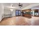 Open concept living area showcasing terracotta tiles, a ceiling fan, ample natural light, and access to the kitchen at 798 Shirley Ln, Boulder City, NV 89005