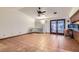 Open concept living room featuring terracotta flooring, a ceiling fan, white walls, and a large glass door and windows at 798 Shirley Ln, Boulder City, NV 89005