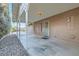 Side view of a covered patio with access to the house, complemented by rock landscaping at 798 Shirley Ln, Boulder City, NV 89005