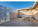 Enclosed patio featuring a metal gate, brick accents, and outdoor seating at 798 Shirley Ln, Boulder City, NV 89005