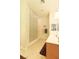 Bright bathroom featuring a glass block shower wall, single vanity, and tile flooring at 814 Lake Hill Dr, Boulder City, NV 89005