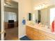 Bathroom with a double vanity and mirror reflecting natural light and a doorway into the adjacent bedroom at 814 Lake Hill Dr, Boulder City, NV 89005