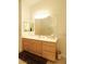 Bathroom featuring a modern vanity with natural wood cabinetry and bright lighting, along with a glass block window shower at 814 Lake Hill Dr, Boulder City, NV 89005