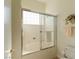 Bathroom featuring a bathtub with sliding glass doors and neutral tiling at 814 Lake Hill Dr, Boulder City, NV 89005