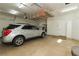 Spacious garage with storage racks above the car and side cabinets at 814 Lake Hill Dr, Boulder City, NV 89005