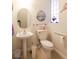 Cozy powder room features a pedestal sink, toilet, and decorative wall art at 814 Lake Hill Dr, Boulder City, NV 89005