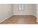 Empty room with wood-look floors and a window at 8140 Redbud Vine St, North Las Vegas, NV 89085