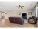 Relaxing living room, bright with natural light, featuring wood-look floors, ceiling fan at 8140 Redbud Vine St, North Las Vegas, NV 89085