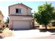 Two-story home with a two-car garage and a well-maintained front yard with mature tree at 8209 Violet Meadow Ct, Las Vegas, NV 89117