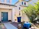 Inviting home exterior features a striking blue front door and well-maintained landscaping at 8209 Violet Meadow Ct, Las Vegas, NV 89117