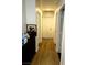 Well-lit hallway with laminate floors and access to multiple rooms at 8209 Violet Meadow Ct, Las Vegas, NV 89117