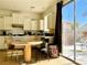Bright kitchen with white cabinetry, appliances, and access to the patio at 8209 Violet Meadow Ct, Las Vegas, NV 89117