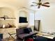Cozy living room featuring tile flooring, ceiling fan and shelving at 8209 Violet Meadow Ct, Las Vegas, NV 89117