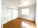 This bedroom features wood floors, a ceiling fan, and a closet with sliding doors at 8257 Gunther Cir, Las Vegas, NV 89145