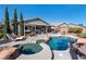 Gorgeous pool and spa combination, covered patio, and desert landscaping create an oasis at 8404 Romantic Sunset St, Las Vegas, NV 89131