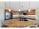 Spacious kitchen featuring wooden cabinets, granite countertops and stainless steel appliances at 8404 Romantic Sunset St, Las Vegas, NV 89131