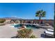 Inviting backyard pool and spa area features a rock waterfall, mature landscaping and mountain views at 8404 Romantic Sunset St, Las Vegas, NV 89131