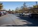 Wide shot of the parking lot with covered spots and multiple vehicles, reflecting a spacious community at 9000 Las Vegas Blvd # 2048, Las Vegas, NV 89123