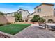 Inviting backyard featuring artificial grass, a paved patio, and elegant outdoor furniture at 9138 Sea Mink Ave, Las Vegas, NV 89149