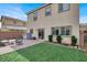 A backyard with an outdoor seating area and a small patch of artificial grass at 9138 Sea Mink Ave, Las Vegas, NV 89149