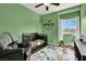 Charming Bedroom with a crib, patterned rug, and a comfortable chair, ideal for a young Gathering at 9138 Sea Mink Ave, Las Vegas, NV 89149