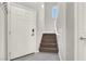 Welcoming entryway with wood stairs, tiled floor, and a white door enhancing the home's appeal at 9138 Sea Mink Ave, Las Vegas, NV 89149