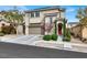 Inviting exterior view of a home with a red front door and freshly landscaped front yard at 9138 Sea Mink Ave, Las Vegas, NV 89149
