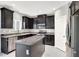 Modern kitchen with dark cabinetry, granite countertops, stainless steel appliances, and a center island at 9138 Sea Mink Ave, Las Vegas, NV 89149