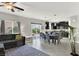Spacious living area flowing into a dining space, featuring tile flooring and large windows for ample light at 9138 Sea Mink Ave, Las Vegas, NV 89149