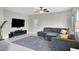 Comfortable living room featuring tile floors, a large sectional sofa, and a mounted flat-screen TV at 9138 Sea Mink Ave, Las Vegas, NV 89149