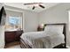 Inviting bedroom featuring a dark wood dresser, large window and a comfortable bed, offering a relaxing space at 9138 Sea Mink Ave, Las Vegas, NV 89149