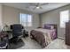 Cozy bedroom with a comfortable bed, a workspace, and a neutral color scheme at 9607 Starfish Reef Way, Las Vegas, NV 89178