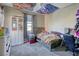 Colorful bedroom with a unique ceiling design, carpet flooring, and window at 9607 Starfish Reef Way, Las Vegas, NV 89178