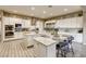 Spacious kitchen featuring dual islands, white cabinets, stainless steel appliances, and tile floors, perfect for cooking at 9607 Starfish Reef Way, Las Vegas, NV 89178