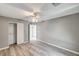 Spacious bedroom featuring wood-look floors, ceiling fan, and closet at 1073 Slate Crossing Ln # 1, Henderson, NV 89002