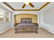 A primary bedroom features a ceiling fan, tray ceiling, and an inviting neutral color palette at 1080 Via Saint Lucia Pl, Henderson, NV 89011