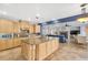 Spacious kitchen with a central island and natural wood cabinets at 1080 Via Saint Lucia Pl, Henderson, NV 89011