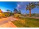 Well-maintained backyard with a lush lawn, mature trees, and a view of the surrounding community at 11342 Winter Cottage Pl, Las Vegas, NV 89135