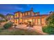 Spacious backyard with manicured landscaping, outdoor seating, and a view of the two-story home at 11342 Winter Cottage Pl, Las Vegas, NV 89135
